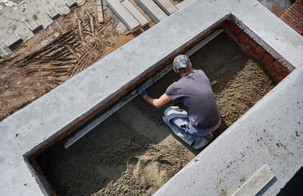male-worker-screeding-floor-construction-site